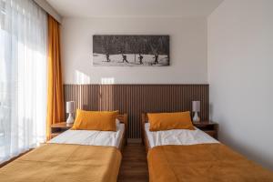 a room with two beds in a room at Willa Bukowina in Bukowina Tatrzańska