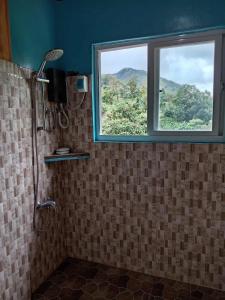 a bathroom with a shower and a window at Cliffhouse Kalinga in Tinglayan +106 photos