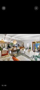 a large living room with couches and a table at Beach House Living in Gordonʼs Bay