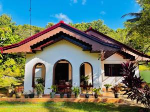 a small white house with plants in the yard at Luna Fortuna Villa in Tangalle
