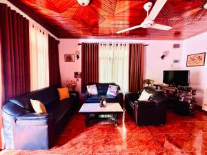 a living room with two couches and a table at Luna Fortuna Villa in Tangalle