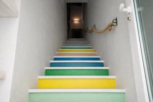 a stairway with colorful steps in a house at Hotiday Polignano Centro - Fico d'India in Polignano a Mare