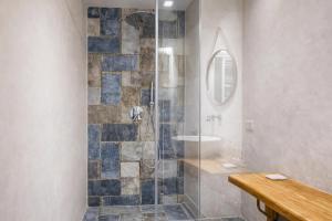 a bathroom with a glass shower with a sink at Hotiday Polignano Centro - Fico d'India in Polignano a Mare
