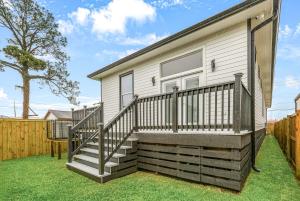 a house with a staircase next to a fence at The Royal Haus NOLA 3 Bed Beauty in New Orleans
