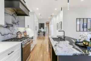 a kitchen with a stove and a counter top at The Royal Haus NOLA 3 Bed Beauty in New Orleans