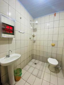 a bathroom with a sink and a toilet at Íkaia Surf House in Ubatuba +49 photos