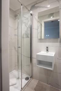 a bathroom with a shower and a sink at MSK Elite in London +23 photos
