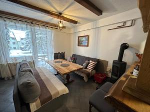 a living room with a couch and a wooden table at Vikendica Anja in Vlasic