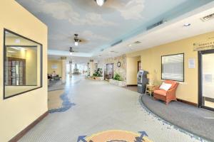 an office lobby with a couch and a chair at Beach Front Resort with Ocean View in Daytona Beach