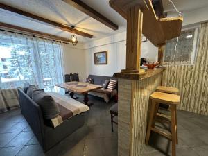 a kitchen and living room with a table and a couch at Vikendica Anja in Vlasic