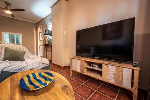a living room with a large flat screen tv at Parque Vera 5 in Vera