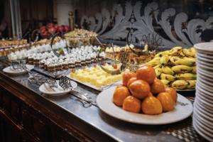 a buffet of food with oranges and other foods at Five-Stars Deluxe River Kruz from Aswan to Luxor 3 Nights in Aswān +24 photos