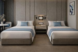 a bedroom with two beds and a table at Five-Stars Deluxe River Kruz from Aswan to Luxor 3 Nights in Aswān