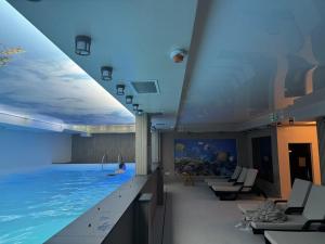 a pool in a hotel with a person swimming in it at Apartman Radmila in Kopaonik