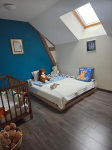 a bedroom with a bed with a teddy bear on it at Le Bel Air en Berry in Reigny