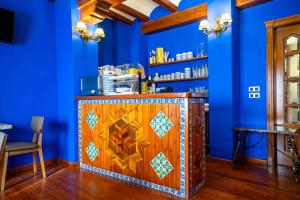 a blue room with a bar with a wooden door at Hotel del Pastor in Morella