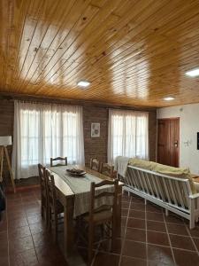 a dining room with a table and chairs at Casa de Descanso Don Abel in Chascomús +3 photos