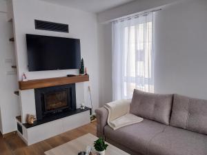 a living room with a couch and a fireplace at Vila Ella Mavrovo in Mavrovo