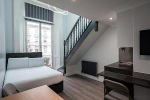 a bedroom with a bed and a stair case at MSK Elite in London