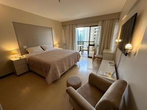 a hotel room with a bed and a couch at Kubitschek Plaza Hotel - Flat Particular ALM in Brasília +44 photos