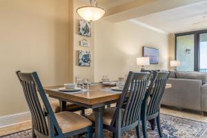 a dining room with a table and chairs at Wave Watcher - Holiday Isle #609 in Dauphin Island