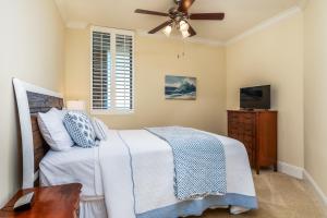 a bedroom with a bed and a ceiling fan at Wave Watcher - Holiday Isle #609 in Dauphin Island