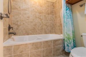 a bathroom with a tub and a toilet at Wave Watcher - Holiday Isle #609 in Dauphin Island +22 photos