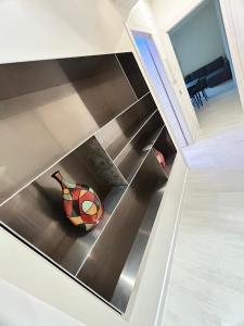 a staircase with a vase sitting on the floor at CARPI SUITE - Appartamenti Minghetti in Carpi