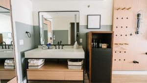 a bathroom with a sink and a mirror at Gravity Haus Moab in Moab +37 photos