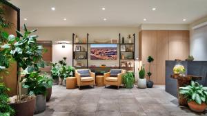 a lobby with chairs and a table in a building at Gravity Haus Moab in Moab
