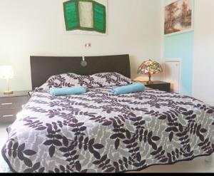 a bedroom with a bed with a black and white comforter at Nice relaxing apartment in Mandria, in Mandria