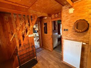 a hallway of a wooden cabin with a staircase and a mirror at Chata Retro in Tatranská Lomnica +13 photos