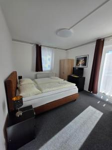 a bedroom with a large bed and a window at Haus Piller in Bad Hofgastein