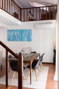 a dining room with a wooden table and chairs at Ermal Green Haven in Vieira do Minho
