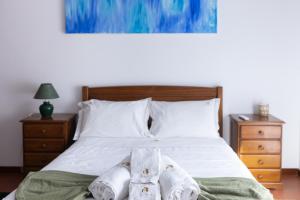 a bedroom with a bed with towels on it at Ermal Green Haven in Vieira do Minho +25 photos