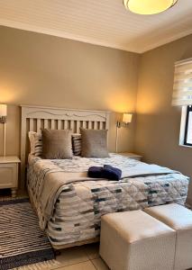 a bedroom with a large bed and a couch at 10 on Sysie in Sedgefield