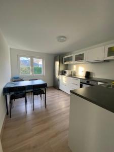 a kitchen with a table and chairs in a room at Burgweg Living in Bad Wildungen +7 photos