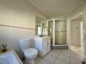 a bathroom with a toilet and a sink and a shower at Sunset View in Durbanville +36 photos