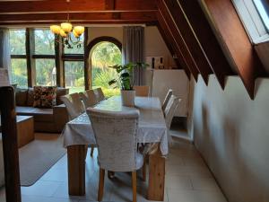 a kitchen and dining room with a table and chairs at The Swiss Garden in Midrand