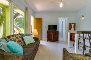 a living room with a couch and a table at Pousada Vila do Bosque in Bombinhas