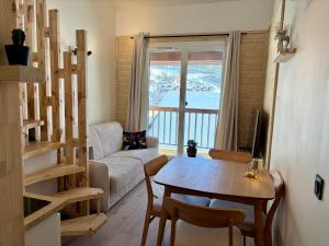 a living room with a table and a couch at Charmant duplex Proche station in Aime-La Plagne