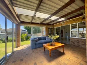a living room with a couch and a table at Sunset View in Durbanville