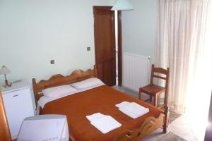 a bedroom with a bed with two towels on it at Γαλήνη in Konitsa