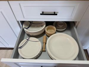 a drawer with plates and utensils in a cabinet at Las eras 84 in Níjar +15 photos