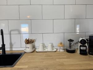 a kitchen counter with utensils and appliances on it at Las eras 84 in Níjar