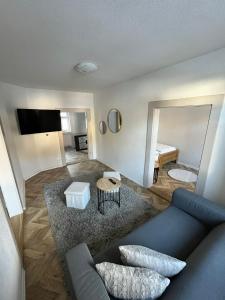 a living room with a blue couch and a mirror at Vila Dom pod Chopkom in Bystrá