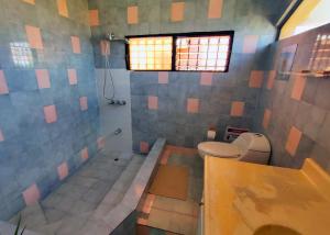 a bathroom with a toilet and a sink and a window at Refugio Encantador in Santo Domingo +54 photos
