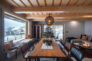 a living room with a table and a christmas tree at Chata Jarabina in Terchová