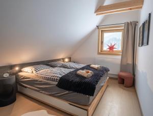 a bedroom with a bed and a window at Chata Jarabina in Terchová