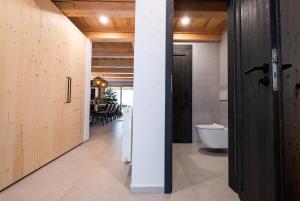 a bathroom with a white toilet and a door at Chata Jarabina in Terchová +57 photos